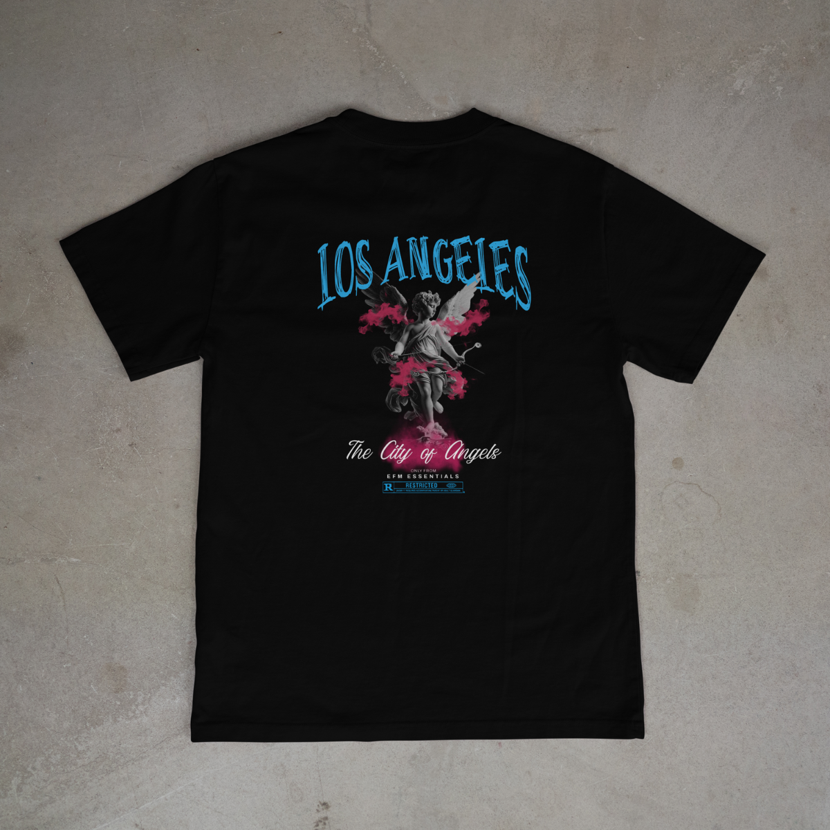 Black t-shirt with 'Los Angeles' and angel graphic on a gray surface