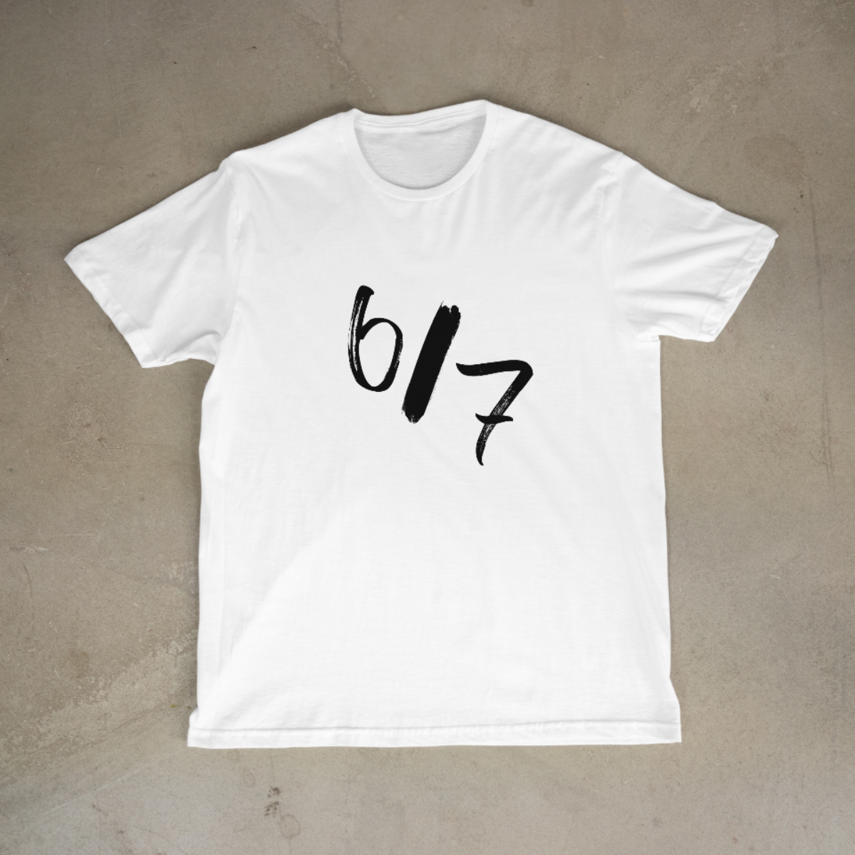 White t-shirt with black text on a beige background