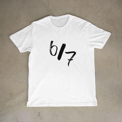 White t-shirt with black text on a beige background