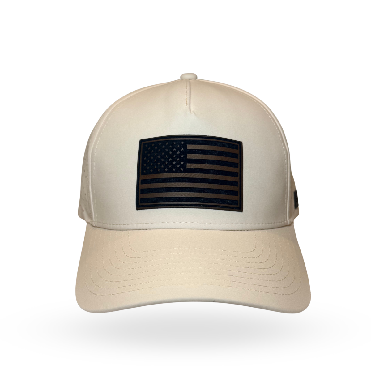 A structured baseball cap in off-white with a black American flag patch on the front, shown against a plain white background.