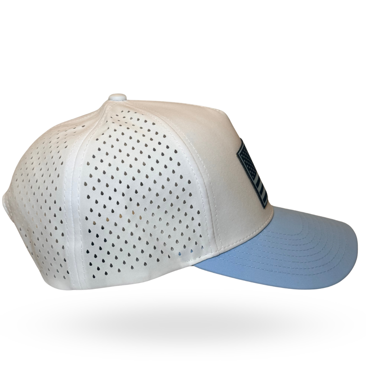 A white baseball cap with perforated front panels and a light blue visor, featuring a black rectangular patch on the side.