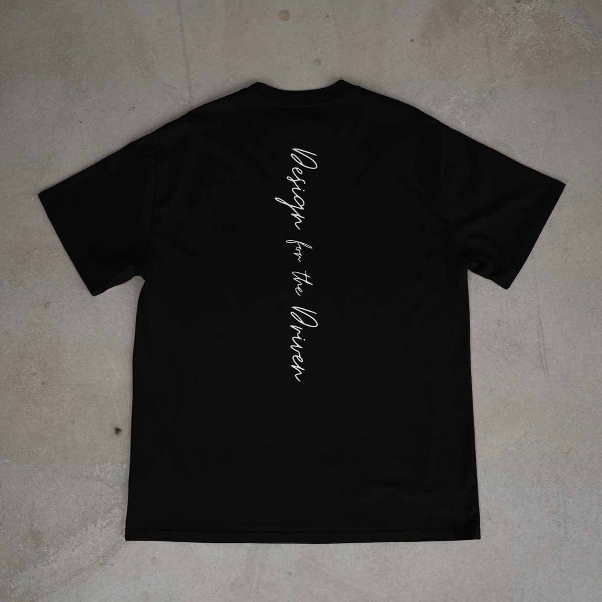 Black t-shirt with white text on a beige surface