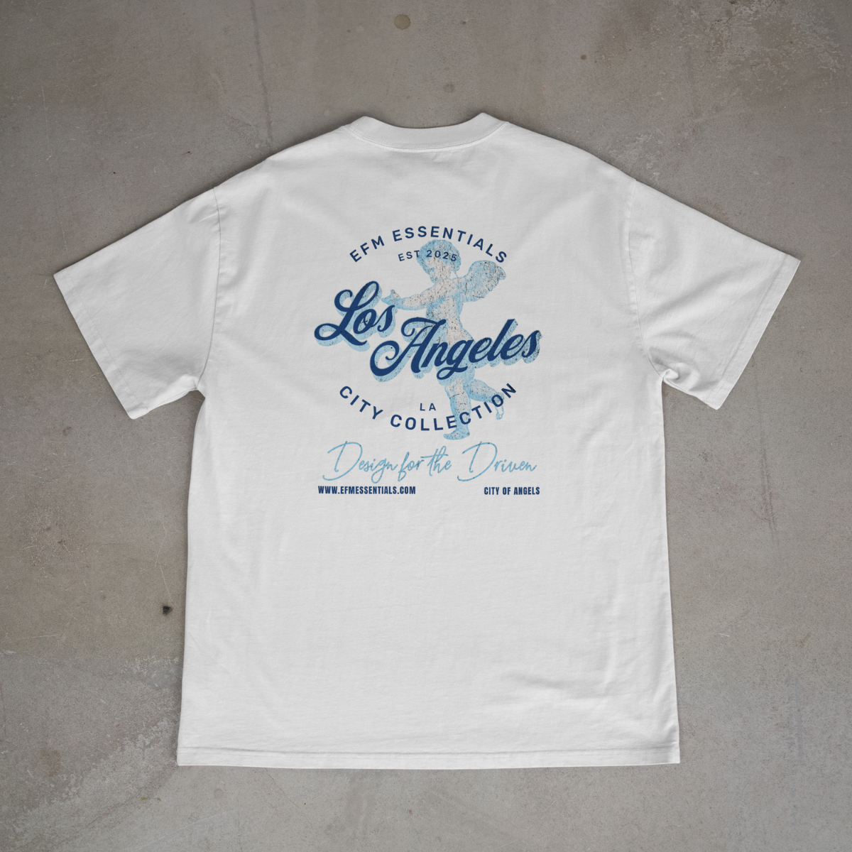 White t-shirt with blue text and graphics on a gray surface