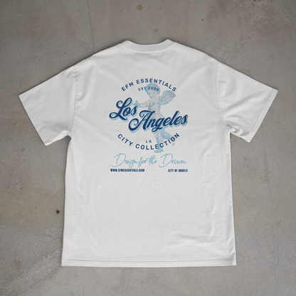 White t-shirt with blue text and graphics on a gray surface