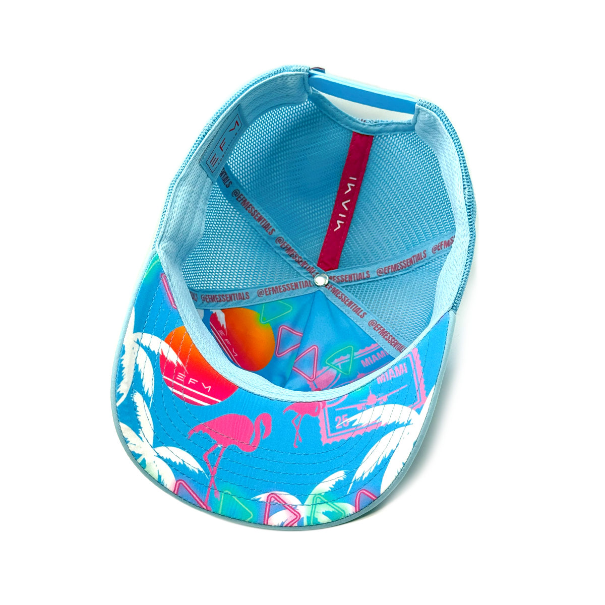Blue cap with flamingo and palm tree pattern on a white background