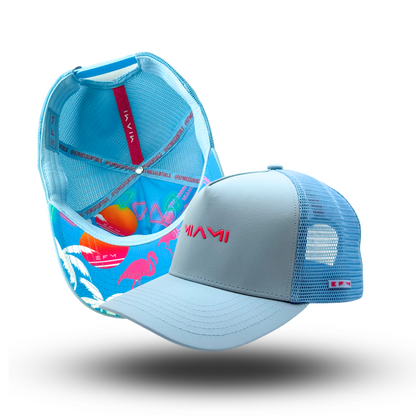 A blue and white trucker hat with a mesh back and an adjustable snap closure, featuring a curved brim and a logo on the front.